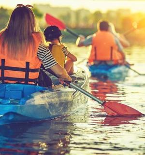a group of people kayaking on a body of water