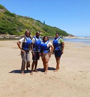 a group of people standing on the beach