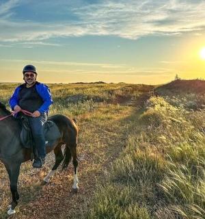 a man riding a horse in a field