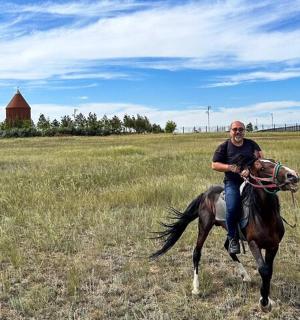 a man riding a horse in a field