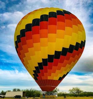 a large colorful hot air balloon in a field