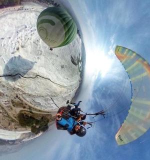 a person flying in the sky with a parachute