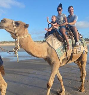 一群人在海滩上骑着骆驼