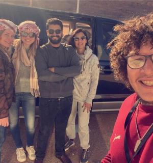 a group of people standing in front of a van