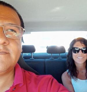 a man and a woman sitting in a car