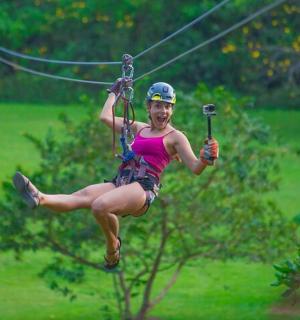 a woman riding on a zip line