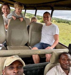 a group of people sitting in the back of a vehicle