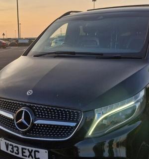 a black car parked in a parking lot