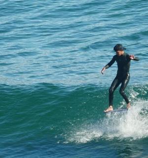 a man riding a wave on a surfboard in the ocean