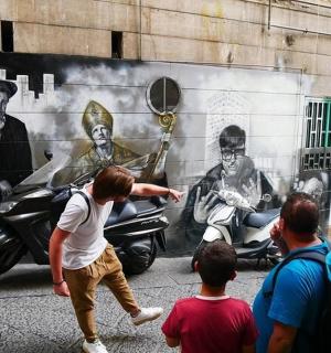 a group of people standing in front of a mural
