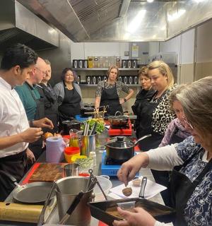 a group of people in a kitchen preparing food