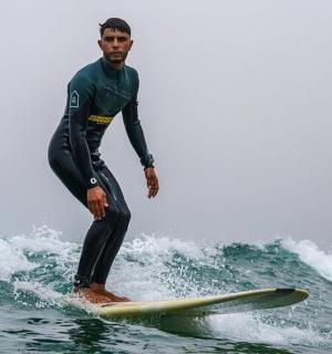 a man riding a wave on a surfboard in the ocean