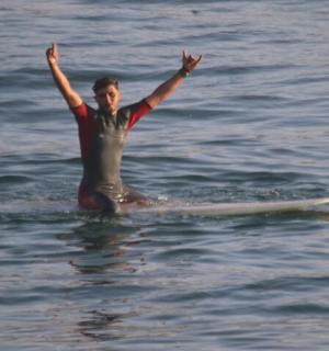 a man sitting on a surfboard in the water