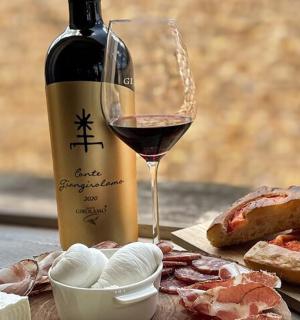 a bottle of wine and a glass of wine and bread