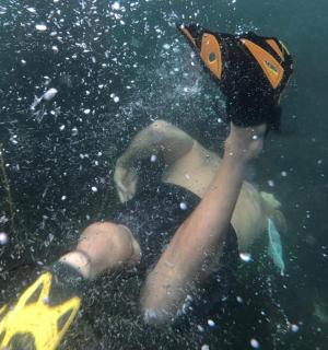 a person floating in the water with a paddle