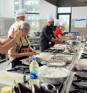 a group of chefs preparing food in a kitchen