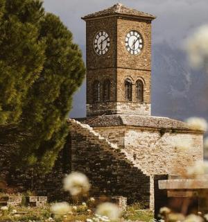 a brick clock tower with a clock on it