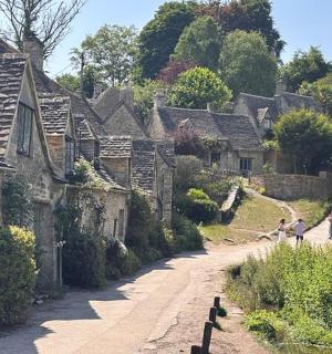 a group of people walking down a village street