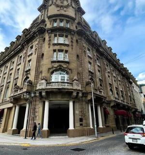 a large building on a city street with cars parked in front
