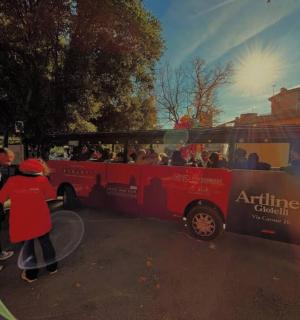 a group of people standing in front of a bus