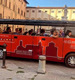 a red bus full of people on a street