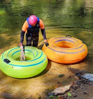 a man standing next to two tubes in the water