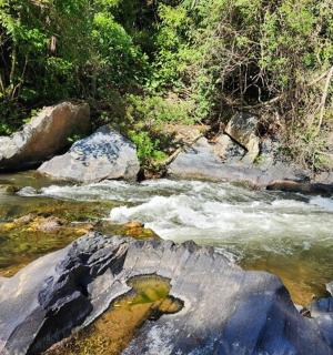 a stream of water with rocks in a river