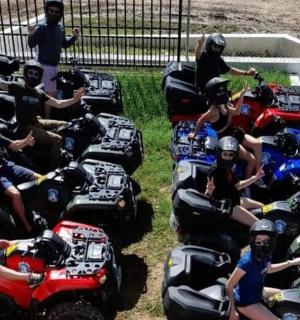 a group of people sitting on atvs in the grass