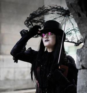 a woman with a hat and an umbrella