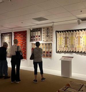 a group of people looking at art in a museum