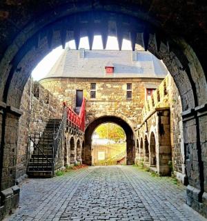 an archway in an old stone building with a building