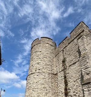 a tall brick building with the sky in the background