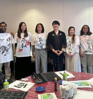 a group of people holding up t shirts in a room