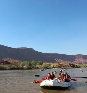 a group of people in a raft on a river