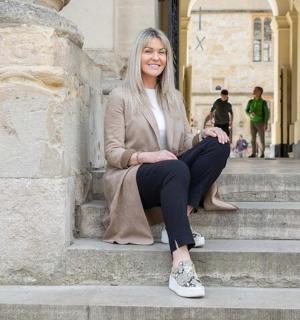 a woman sitting on the steps of a building