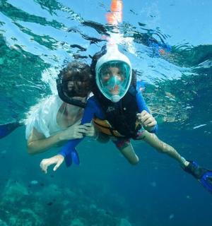 two people are swimming in the water