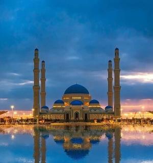 a mosque with two domes and two minarets