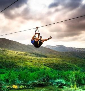 a person is hanging on a zip line