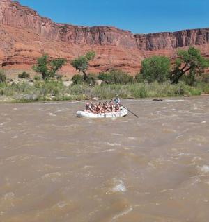 a group of people in a boat on a river