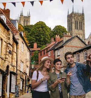 a group of three people standing in a street