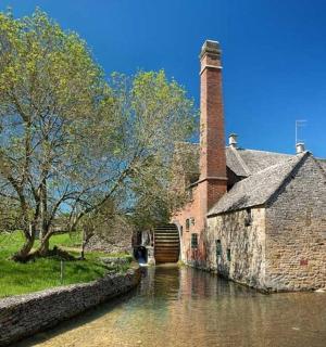 an old building in the water next to a canal