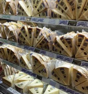a store shelf filled with lots of cheese