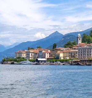 a large body of water with buildings and mountains