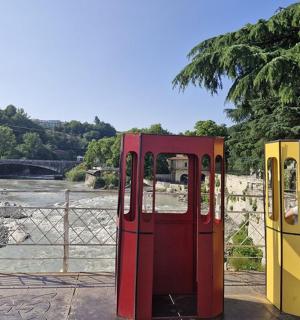 two vending machines are sitting next to a river