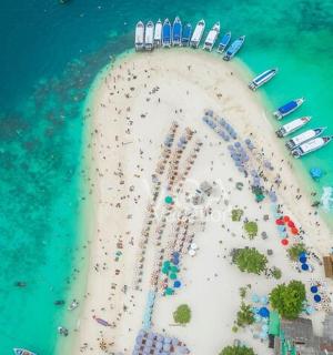 an aerial view of a beach with a crowd of people