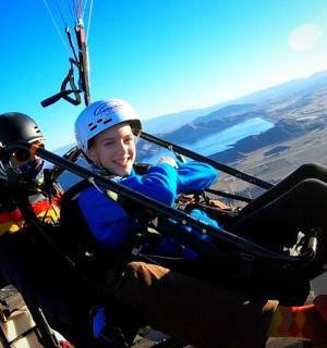 two children are riding in a parachute