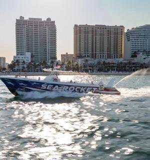 a boat in the water with buildings in the background