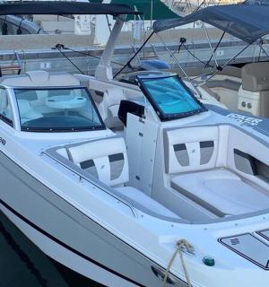 a white boat is docked in the water