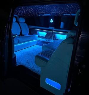 a back seat of a limo with blue lights