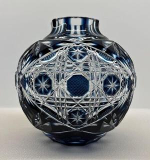 a black glass vase sitting on a table